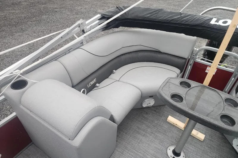 Slide: The Image of 2021 Lowe SS 230 WT pontoon boat with gray seating and protective cover. - 20