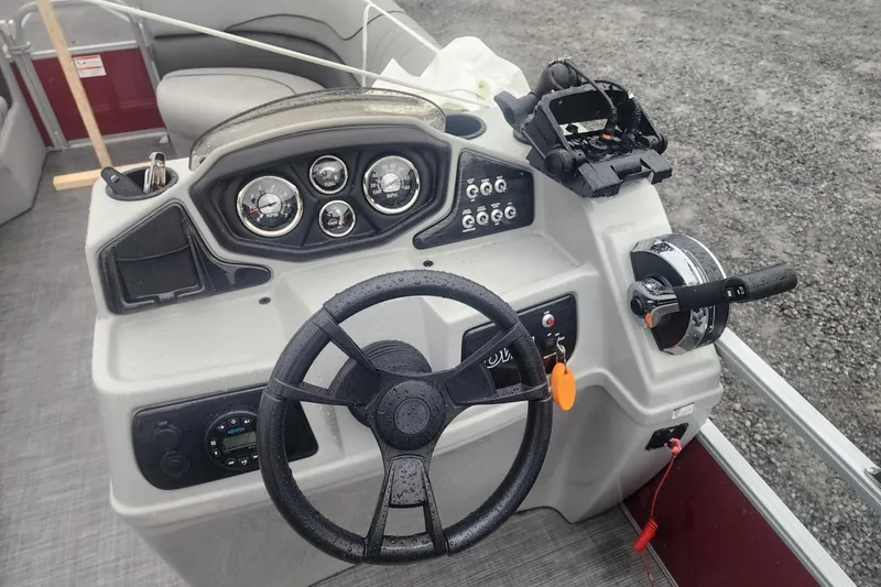 Slide: The Image of 2021 Lowe SS 230 WT pontoon boat interior with gray seating and steering console. - 21