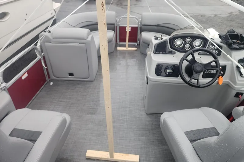 Slide: The Image of 2021 Lowe SS 230 WT boat interior with gray seating and cup holders. - 22
