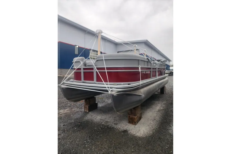 Slide: The Image of 2021 Lowe SS 230 WT pontoon boat on blocks in a storage area. - 4