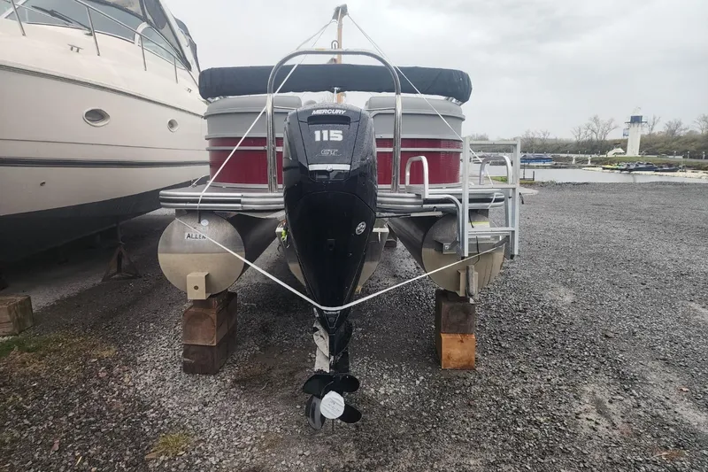 Slide: The Image of 2021 Lowe SS 230 WT pontoon boat on display in a boatyard. - 8