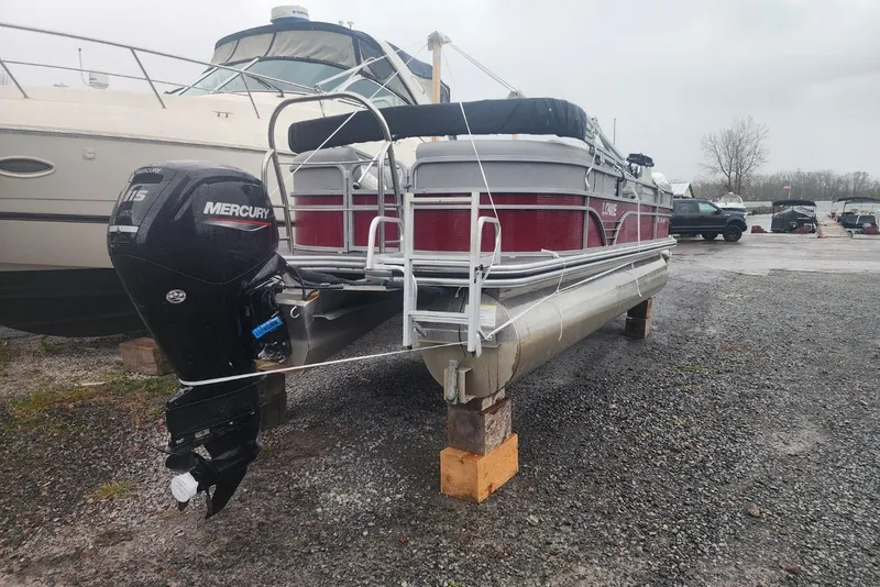 Slide: The Image of 2021 Lowe SS 230 WT pontoon boat secured on blocks in a boatyard. - 9