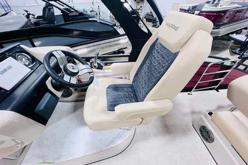 Slide: The Image of 2025 Harris Solstice 250 boat interior with steering wheel and luxurious seating. - 13