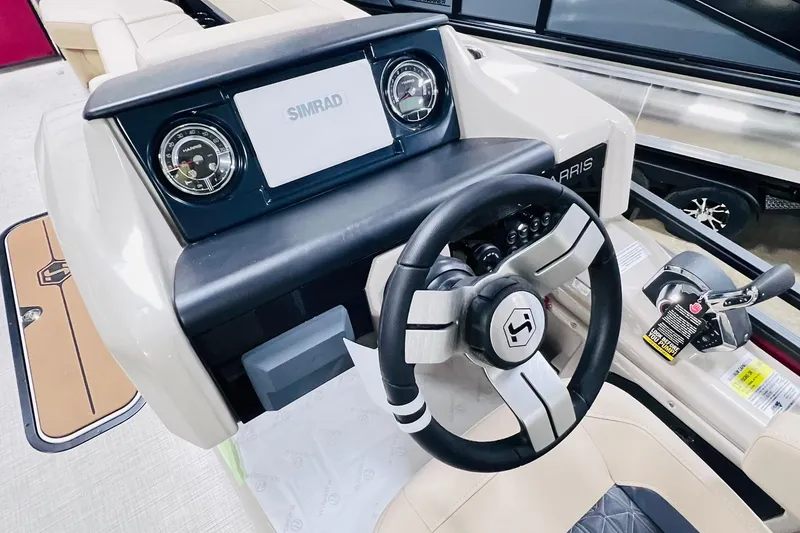 Slide: The Image of 2025 Harris Solstice 250 boat dashboard with steering wheel and control panel. - 14