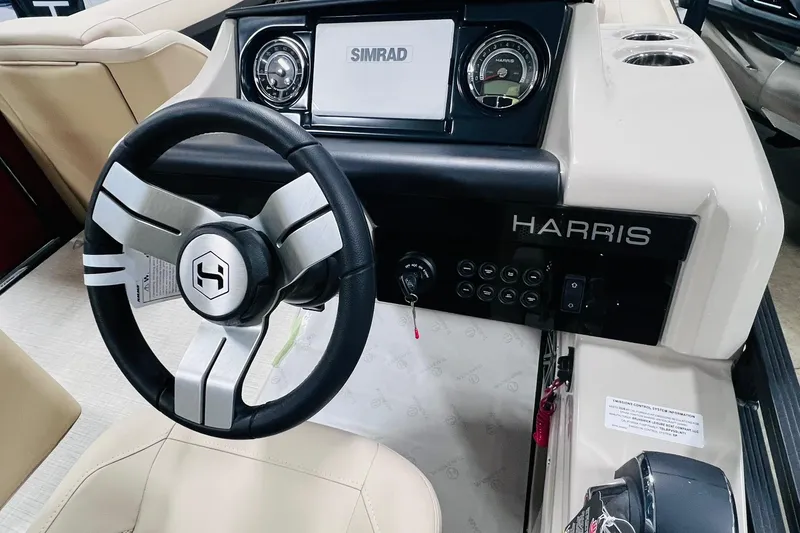 Slide: The Image of 2025 Harris Solstice 250 boat dashboard with steering wheel and control panel. - 17