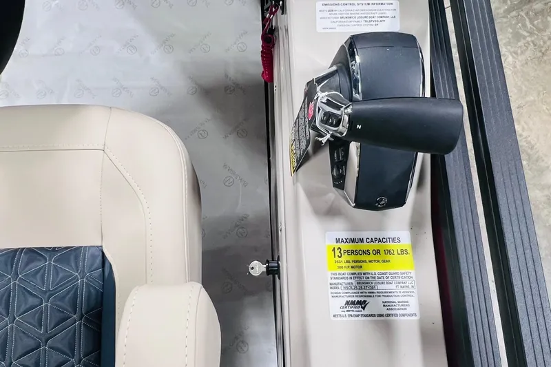 Slide: The Image of Control panel of 2025 Harris Solstice 250 boat with seating capacity label. - 19