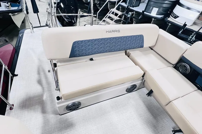 Slide: The Image of 2025 Harris Solstice 250 boat interior with beige seating and blue accents. - 26