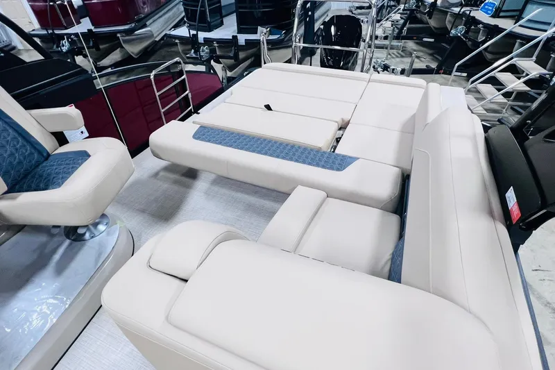 Slide: The Image of 2025 Harris Solstice 250 boat interior with beige seating and blue accents. - 33