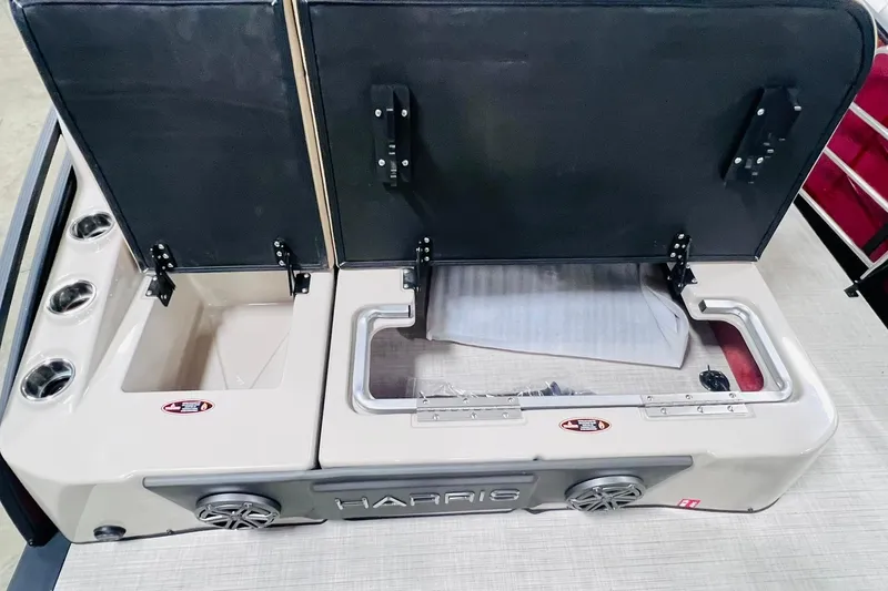 Slide: The Image of 2025 Harris Solstice 250 boat storage compartments with open lids and cup holders. - 39