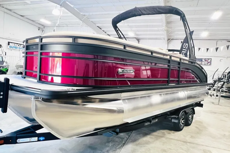 Slide: The Image of 2025 Harris Solstice 250 pontoon boat in showroom, featuring sleek design and vibrant red color. - 4