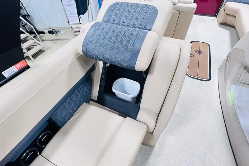Slide: The Image of 2025 Harris Solstice 250 boat interior with beige seating and built-in storage compartment. - 47