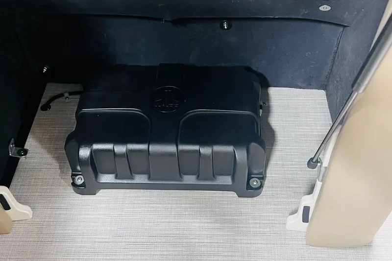 Slide: The Image of 2025 Harris Solstice 250 storage compartment with black protective cover. - 50