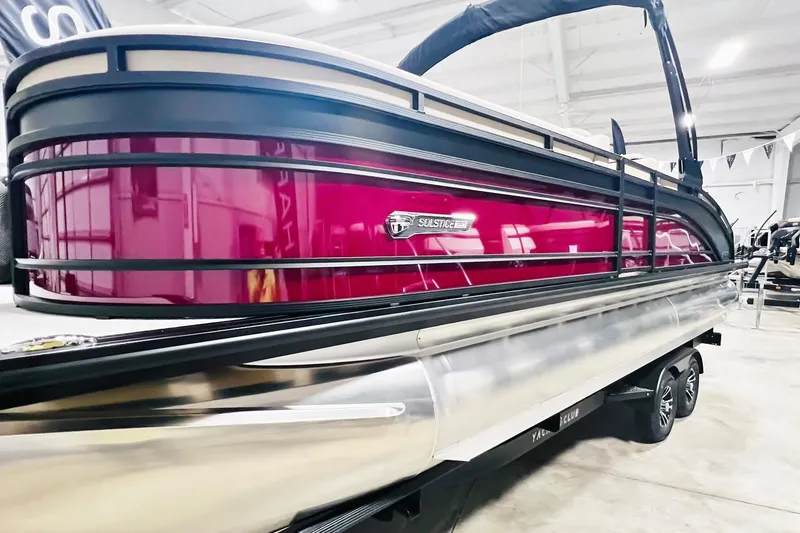 Slide: The Image of 2025 Harris Solstice 250 pontoon boat with sleek design and vibrant color in showroom. - 51