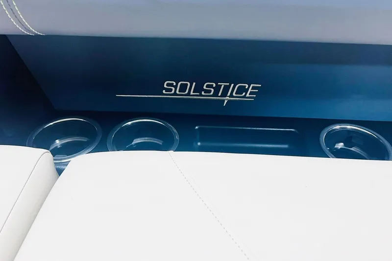 Slide: The Image of 2025 Harris Solstice 250 interior with cup holders and logo detail. - 58