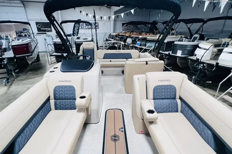 Slide: The Image of 2025 Harris Solstice 250 pontoon boat interior with luxurious seating in showroom. - 8