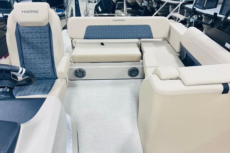 Slide: The Image of 2025 Harris Solstice 250 boat interior with beige and blue seating, featuring modern design. - 9