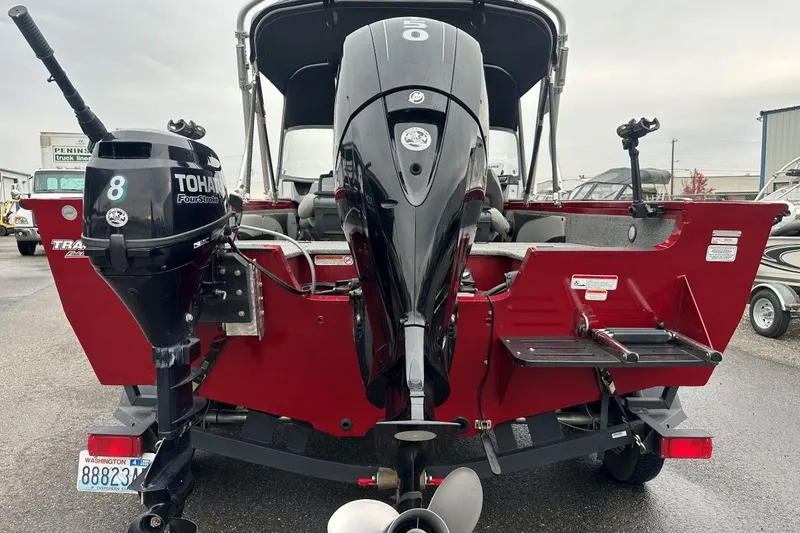 Slide: The Image of 2019 Tracker Targa V-19 Combo boat with dual outboard motors, red exterior. - 8