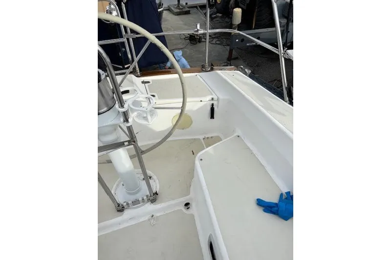 Slide: The Image of 1988 Tartan 31 Cutter Rigged Masthead Sloop cockpit with steering wheel and seating area. - 13