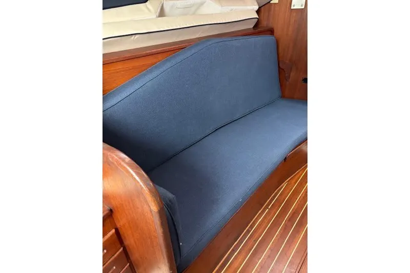 Slide: The Image of Blue cushioned seating on 1988 Tartan 31 Cutter Rigged Masthead Sloop, wooden interior. - 25