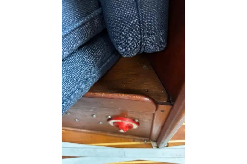 Slide: The Image of Interior detail of 1988 Tartan 31 Cutter Rigged Masthead Sloop, featuring blue upholstery and wooden finish. - 26