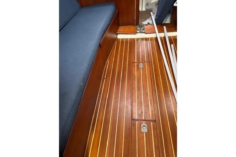 Slide: The Image of Interior view of 1988 Tartan 31 Cutter Rigged Masthead Sloop with wooden flooring. - 27