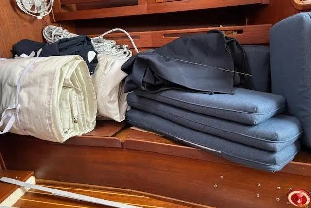 Slide: The Image of Interior of 1988 Tartan 31 Cutter Sloop with folded sails and cushions. - 29