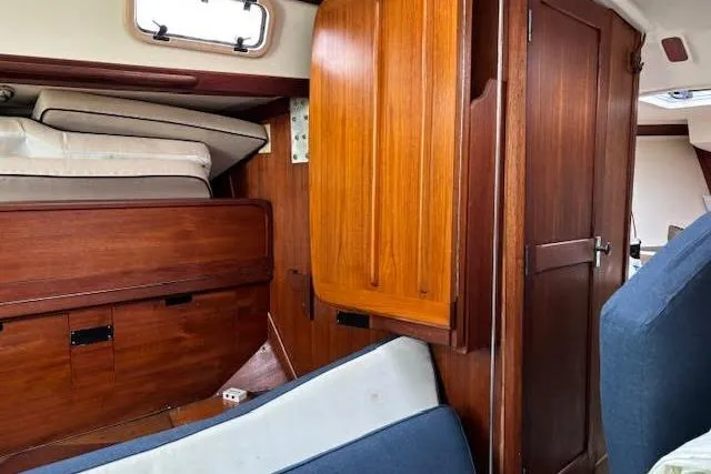 Slide: The Image of Interior of 1988 Tartan 31 Cutter Rigged Masthead Sloop with wooden cabinetry and seating. - 31