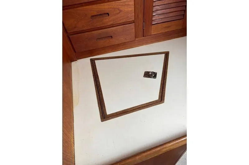 Slide: The Image of Interior of 1988 Tartan 31 Cutter Rigged Masthead Sloop with wooden cabinetry and hatch. - 35