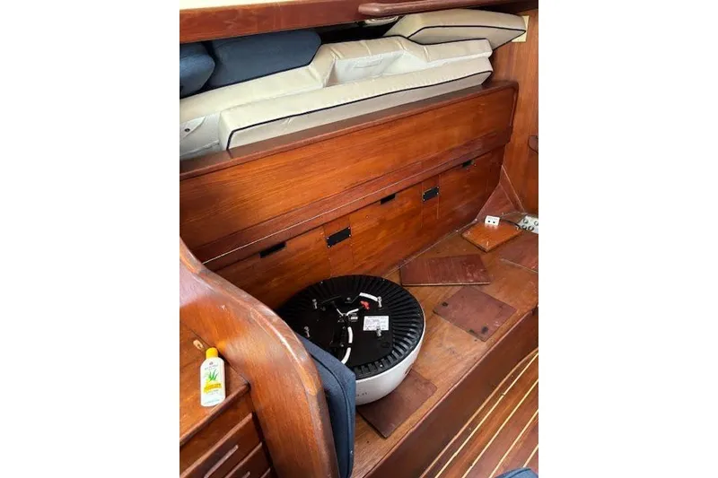 Slide: The Image of Interior of 1988 Tartan 31 Cutter Rigged Masthead Sloop with wooden storage and cushions. - 38