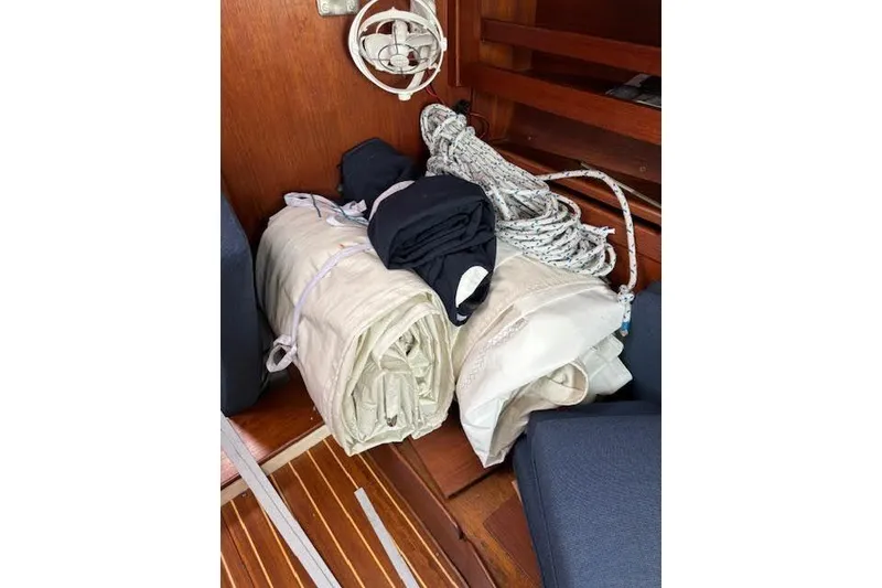 Slide: The Image of Rolled sails and ropes inside a 1988 Tartan 31 Cutter Rigged Masthead Sloop. - 44