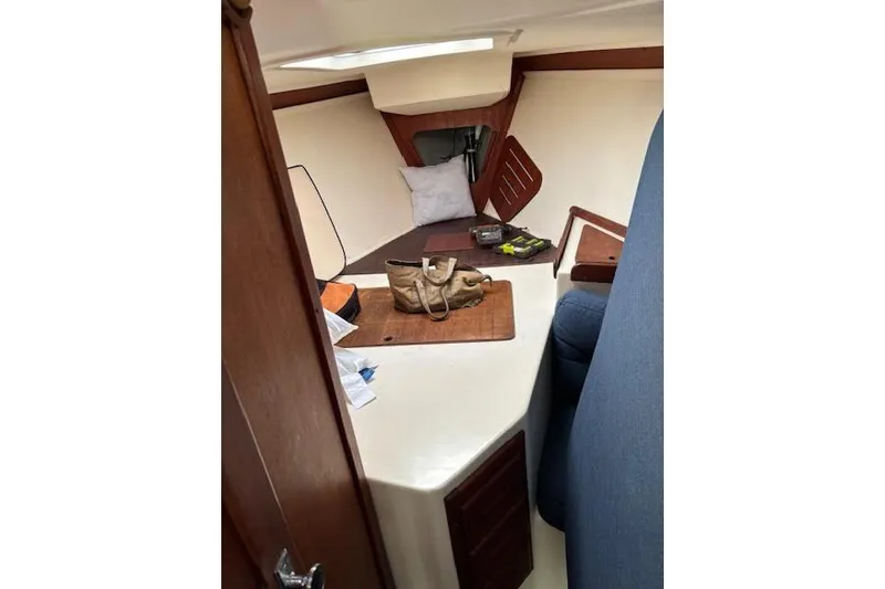 Slide: The Image of Interior of 1988 Tartan 31 Cutter Rigged Masthead Sloop, featuring cozy cabin space. - 49