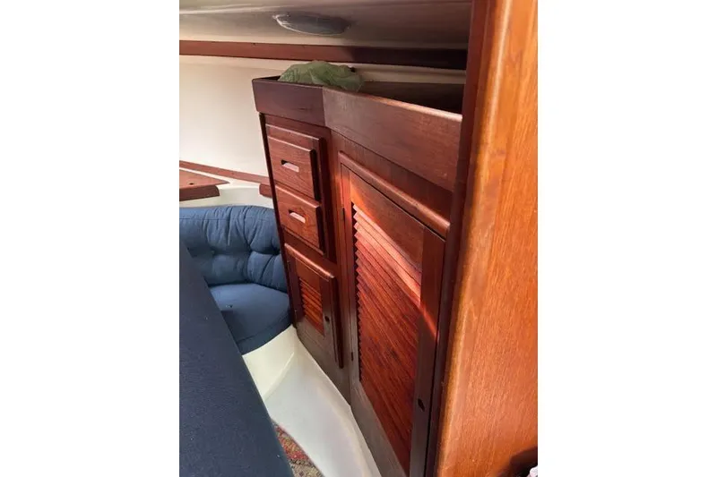 Slide: The Image of Interior of 1988 Tartan 31 Cutter Rigged Masthead Sloop with wooden cabinetry and seating. - 50