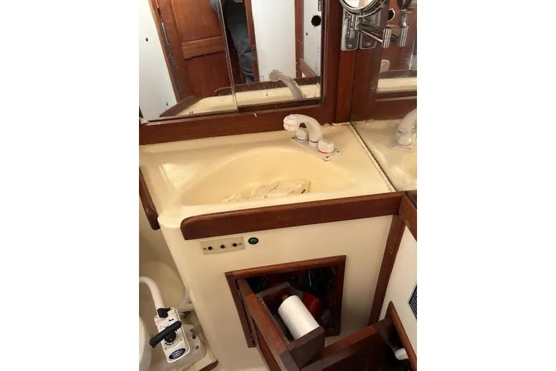 Slide: The Image of 1988 Tartan 31 Cutter Rigged Sloop bathroom with sink, mirror, and storage. - 51