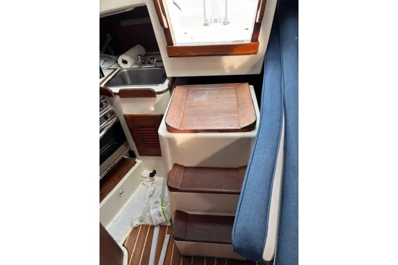 Slide: The Image of Interior of 1988 Tartan 31 Cutter Rigged Masthead Sloop with wooden steps and compact kitchen. - 55