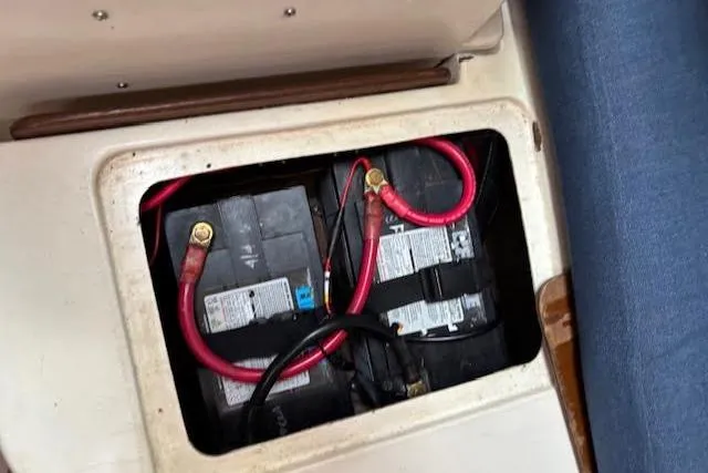 Slide: The Image of Battery compartment of 1988 Tartan 31 Cutter Rigged Masthead Sloop with red cables. - 58