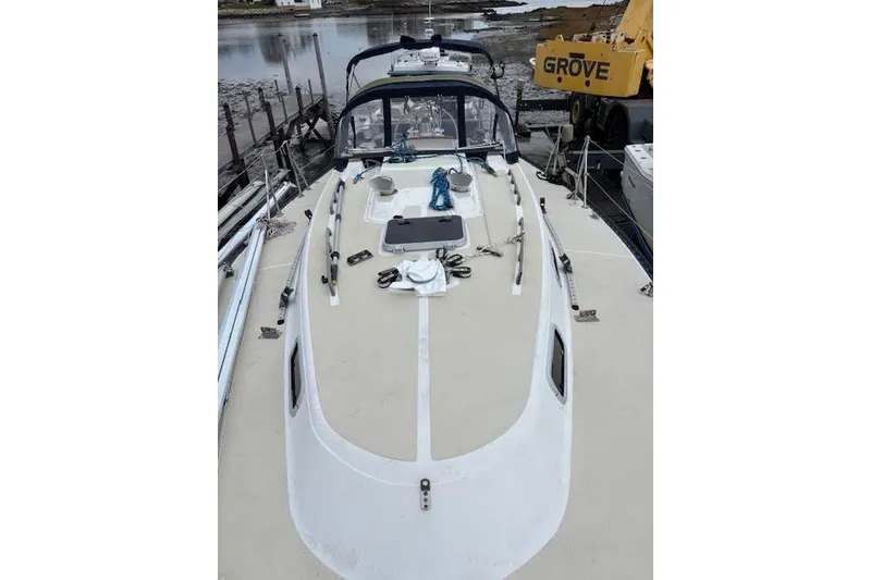 Slide: The Image of 1988 Tartan 31 Cutter Rigged Masthead Sloop on deck, docked near water. - 6