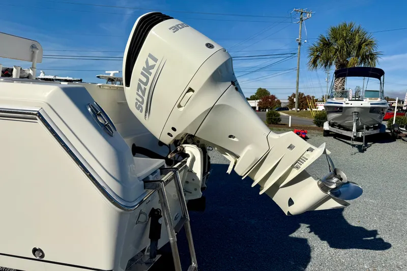 Slide: The Image of 2016 Sailfish 240 CC boat with Suzuki 300 outboard motor in a sunny marina. - 32