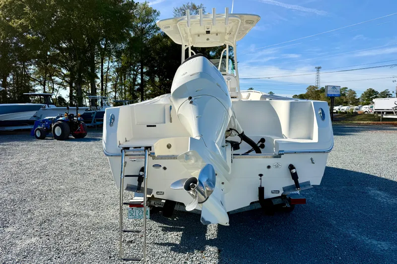 Slide: The Image of 2016 Sailfish 240 CC boat with outboard motor, parked on gravel lot. - 33
