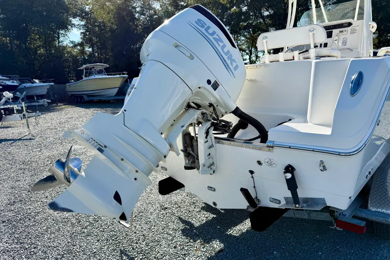 Slide: The Image of 2016 Sailfish 240 CC boat with Suzuki outboard motor in a gravel lot. - 34