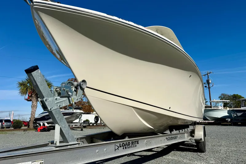Slide: The Image of 2016 Sailfish 240 CC boat on trailer under clear blue sky. - 40