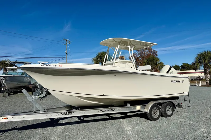 Slide: The Image of 2016 Sailfish 240 CC boat on trailer under clear blue sky. - 41