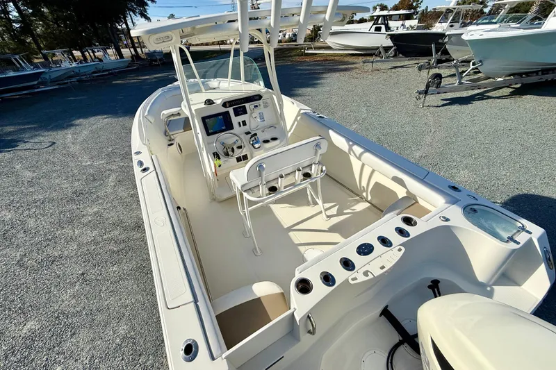 Slide: The Image of 2016 Sailfish 240 CC boat with spacious deck and modern controls. - 42