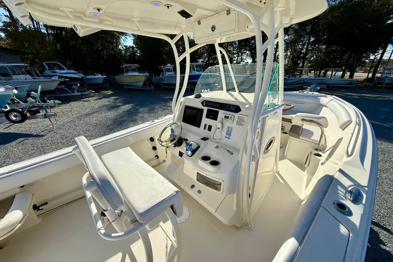 Slide: The Image of 2016 Sailfish 240 CC boat interior with helm, seating, and controls. - 48