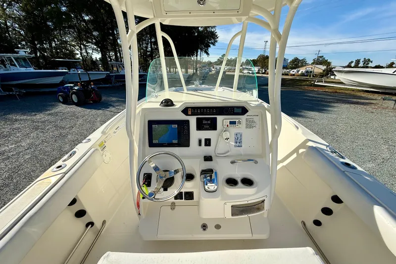 Slide: The Image of 2016 Sailfish 240 CC boat cockpit with steering wheel and navigation controls. - 50