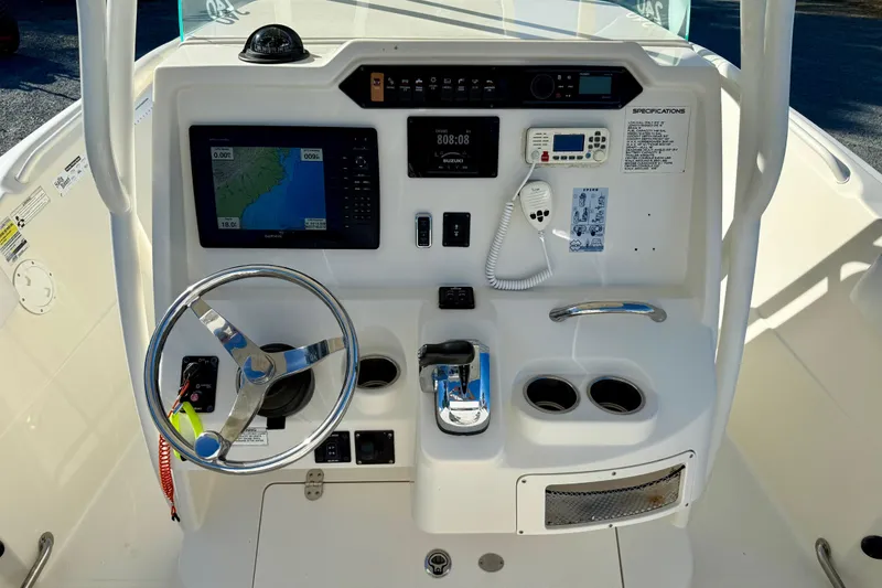 Slide: The Image of 2016 Sailfish 240 CC boat dashboard with steering wheel, navigation screen, and controls. - 51
