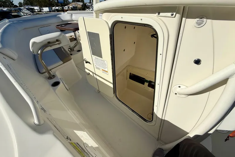 Slide: The Image of 2016 Sailfish 240 CC boat interior with open storage compartment. - 57