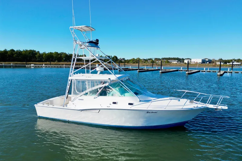 The Image of 1996 Cabo 35 boat on calm water with clear blue sky. - 0