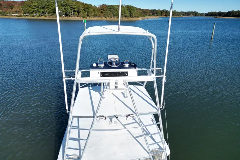 Slide: The Image of Aerial view of 1996 Cabo 35 boat on calm water near a wooded shoreline. - 10