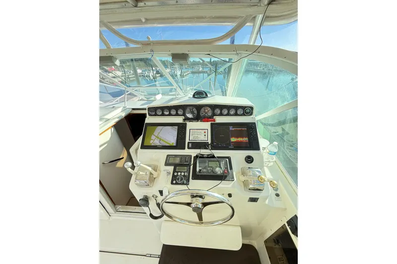 Slide: The Image of 1996 Cabo 35 boat dashboard with Garmin navigation display and gauges. - 13