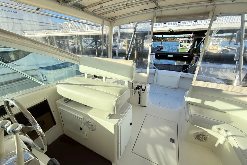 Slide: The Image of Interior of a 1996 Cabo 35 yacht with white seating. - 18